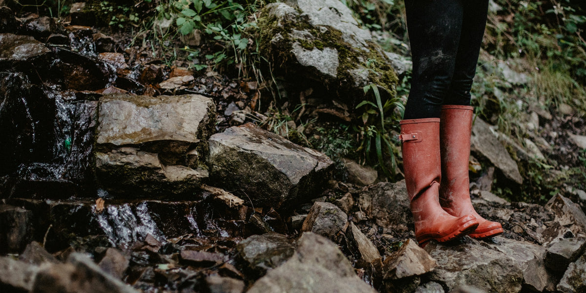 Red boots on rocky ground