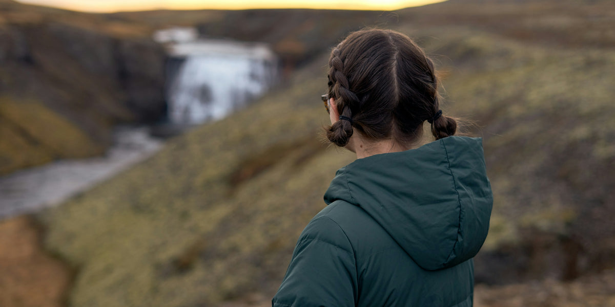 Hiker looking towards a waterfall
