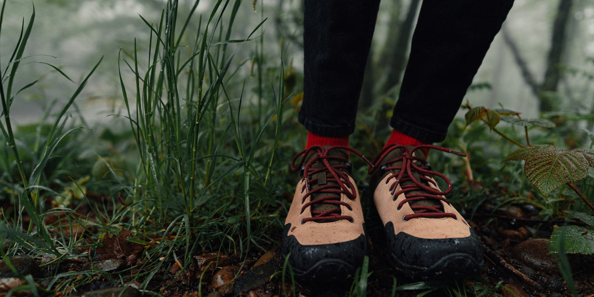 Hiking boots on a trail in a misty forest