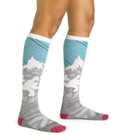 Close up studio shot of model wearing the Darn Tough Yeti over-the-calf ski sock in Aqua