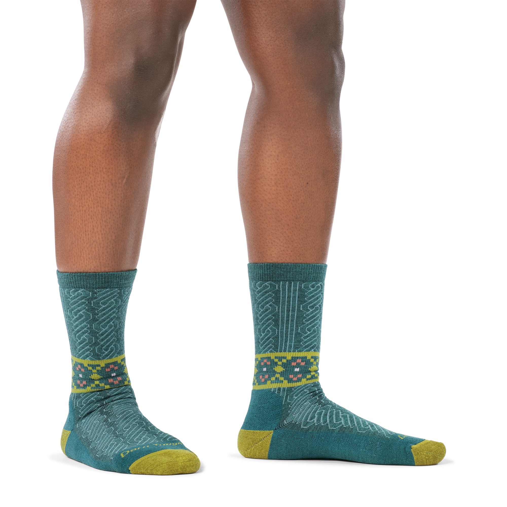 Model barefoot in a staggered stance wearing the Darn Tough Nordic Twist Crew sock in Teal, side profile